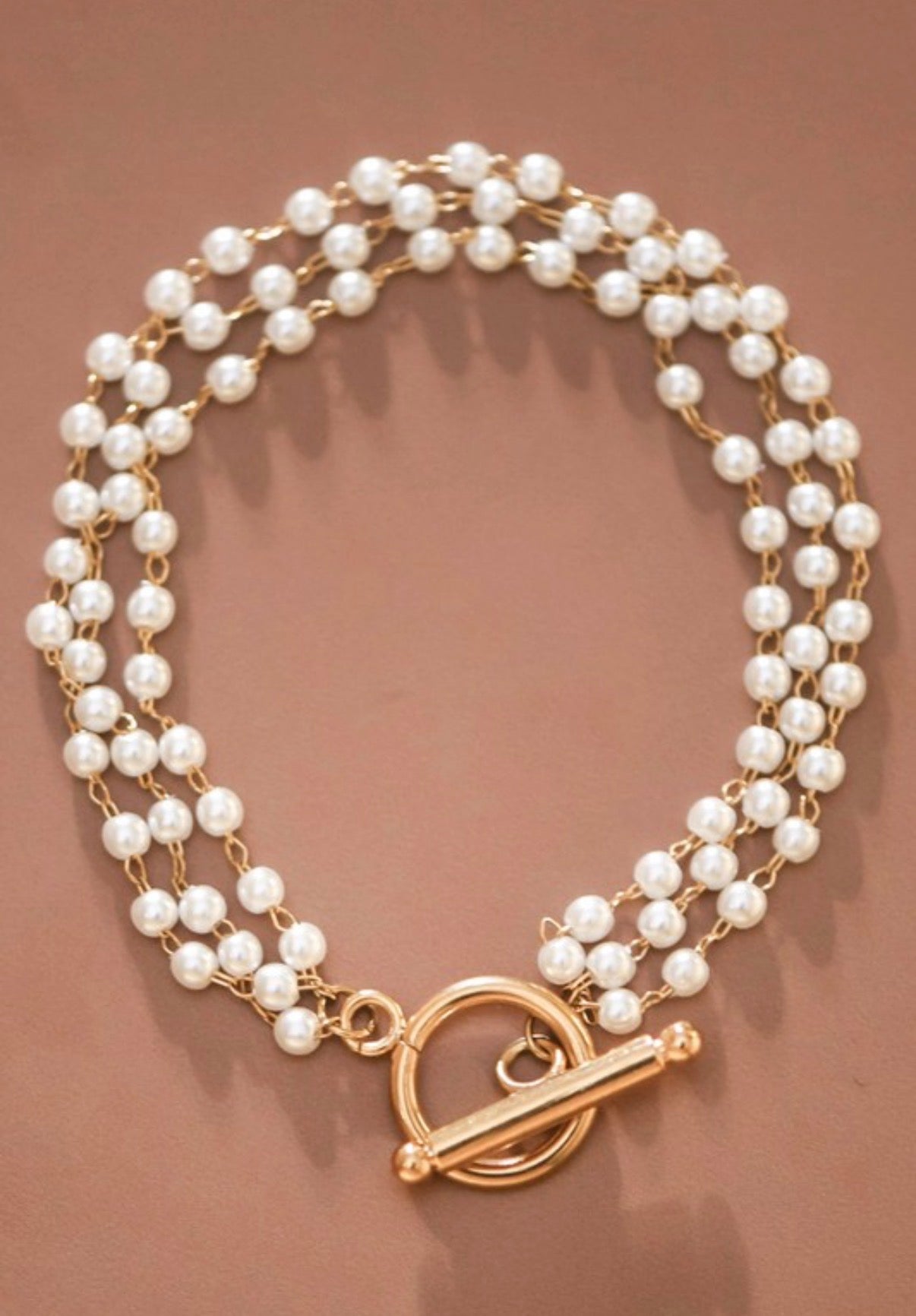 Dainty18K gold plated stainless steel multi-string pearl bracelet.