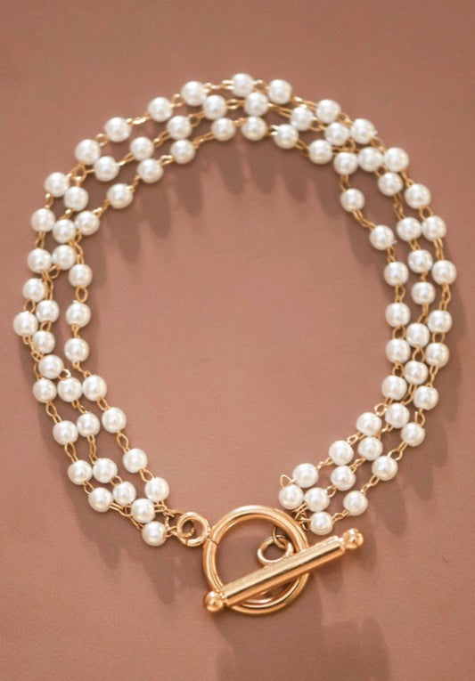 Dainty18K gold plated stainless steel multi-string pearl bracelet.