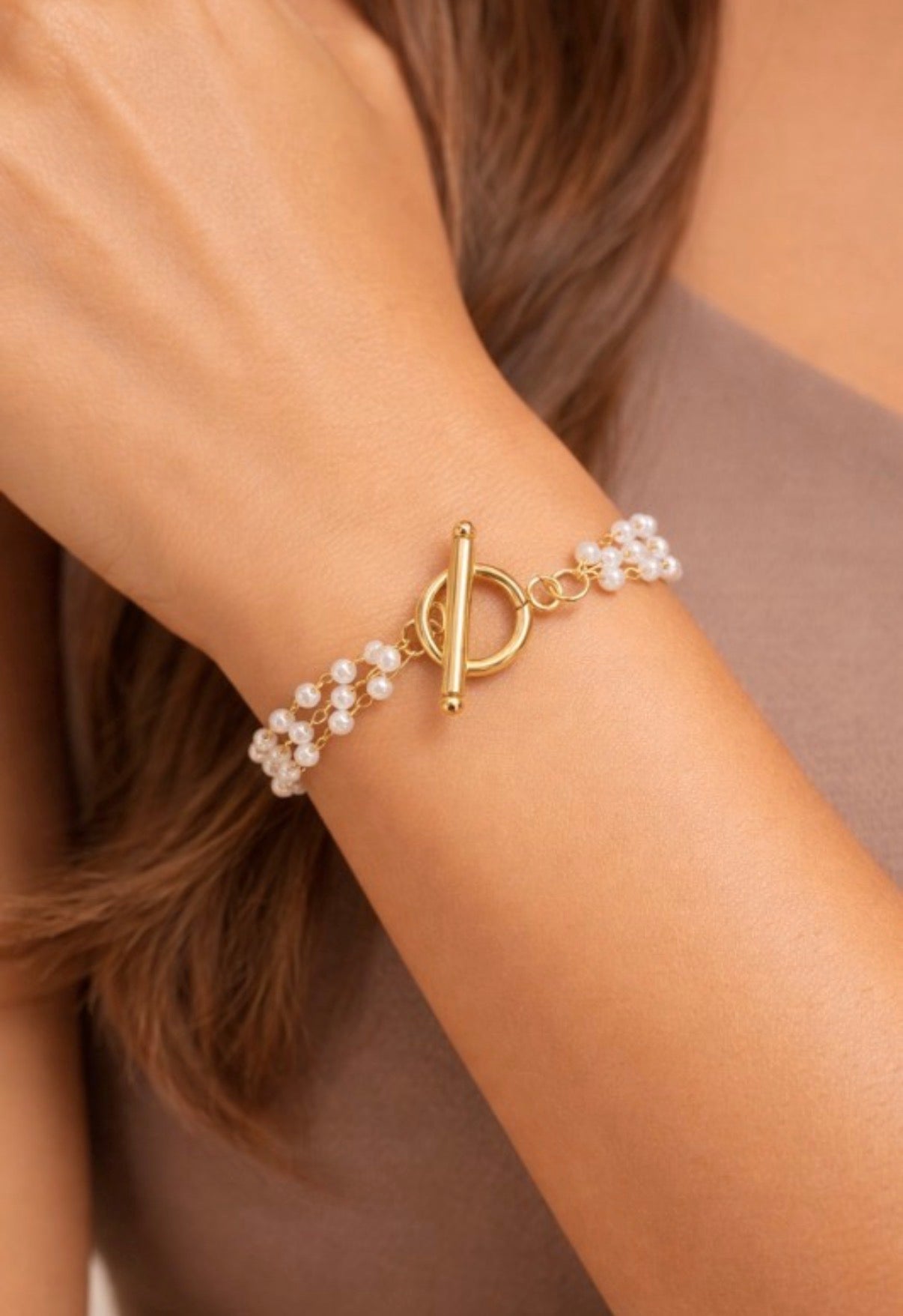Dainty18K gold plated stainless steel multi-string pearl bracelet.